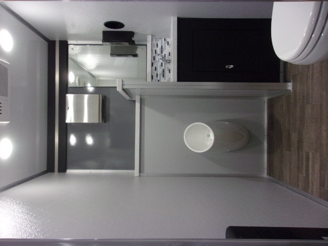 Full luxury restroom interior with vanity, mirror, and wood floor